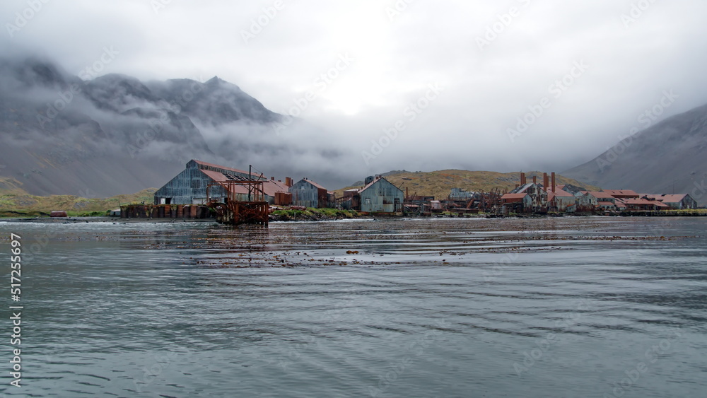 Rusted remains of a whaling station at Leith Harbor, South Georgia Island, under overcast skies