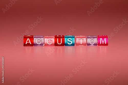Foto the word accustom made up of cubes