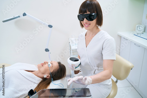 Doctor and patient during the procedure of photorejuvenation of the skin