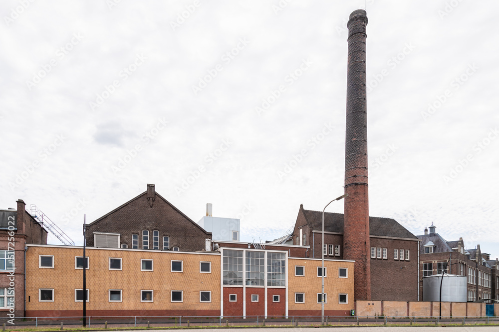 Industrial buildings of the old machine factory Stork with a high chimney on the Stork complex in Hengelo.