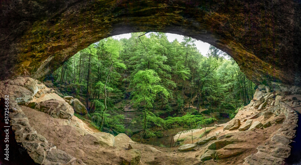 Looking out onto woods from within, Old Man’s Cave is a large recess cavern in the side wall of a beautiful, sandstone canyon in scenic Hocking Hills State Park, Ohio. Looking out onto woods from within, Old Man’s Cave is a large recess cavern in the side wall of a beautiful, sandstone canyon in scenic Hocking Hills State Park, Ohio.