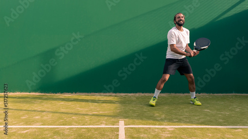 A caucasian padel player jump to the ball, good looking for posts and poster. © REC Stock Footage
