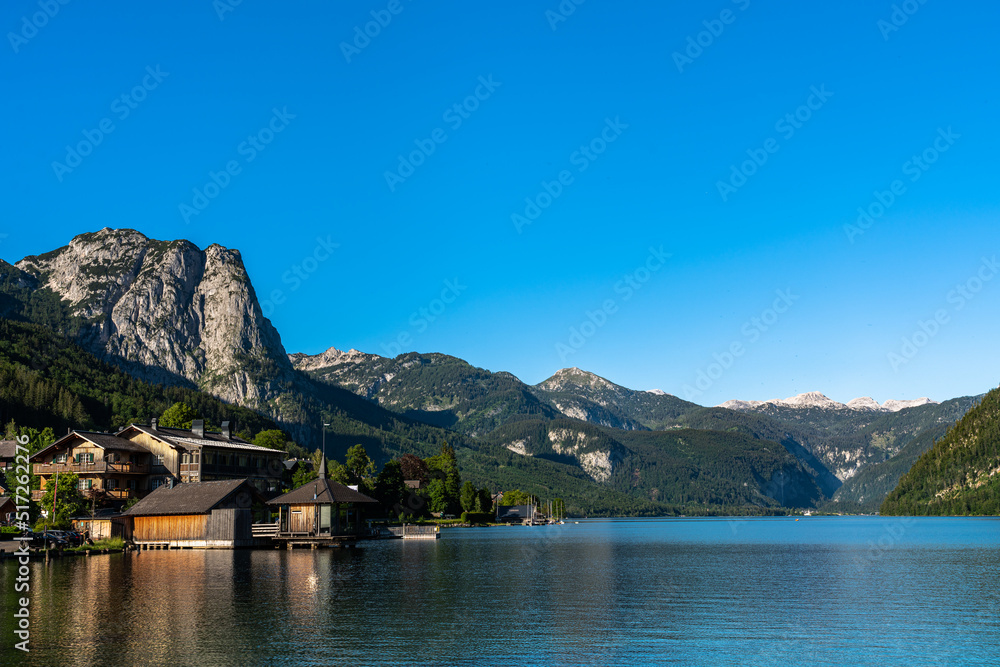 Stunning panorama view of Grundlsee lake with peaks of Styrian Alps in background on a sunny summer day, Styria, Austria