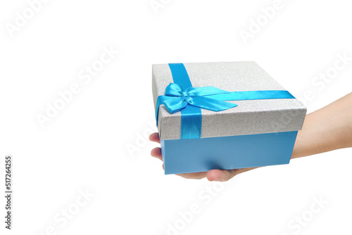 Fototapeta Naklejka Na Ścianę i Meble -  Gift box with blue ribbon and bow in hand white background.