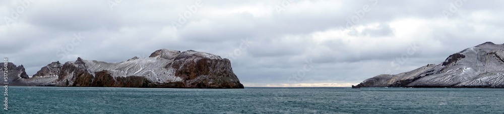 Panorama of snow dusted mountains around the pass at the entrance to the crater bay in Deception Island, Antarctica Panorama of snow dusted mountains around the pass at the entrance to the crater bay in Deception Island, Antarctica