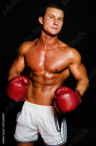 Young attractive boxer posing in the studio.