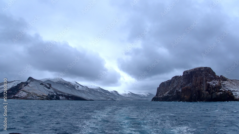 Snow dusted mountains around the pass at the entrance to the crater bay in Deception Island, Antarctica