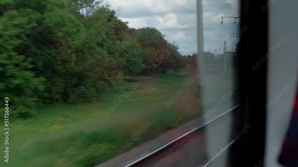 side view of high-speed turning train on landscape of beautiful nature wild field and mountains forest on cloudy sunny day in summer background. Transport, travel, railway, communication concept side view of high-speed turning train on landscape of beautiful nature wild field and mountains forest on cloudy sunny day in summer background. Transport, travel, railway, communication concept