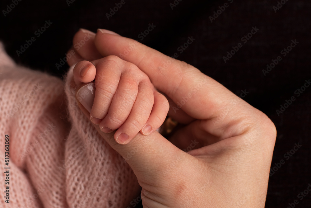 Portrait of cute bab, hand of mom and baby
Portrait of cute bab, hand of mom and baby