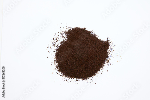 overhead shot of pile of coffee grounds isolated on white background 