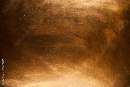 Liquid fluid art abstract background. Ocher jets and smoke rings dancing acrylic paints underwater, space ocean, color explosion photo