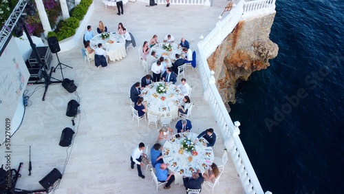 Aerial view of people after wedding ceremony on the cliff. 