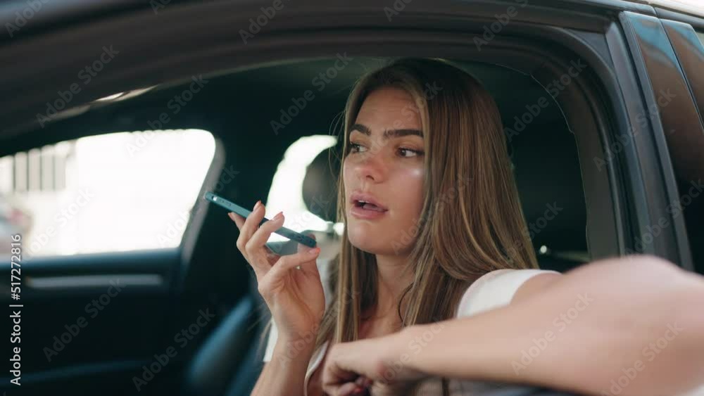 Young woman talking on the smartphone sitting on car at street Young woman talking on the smartphone sitting on car at street