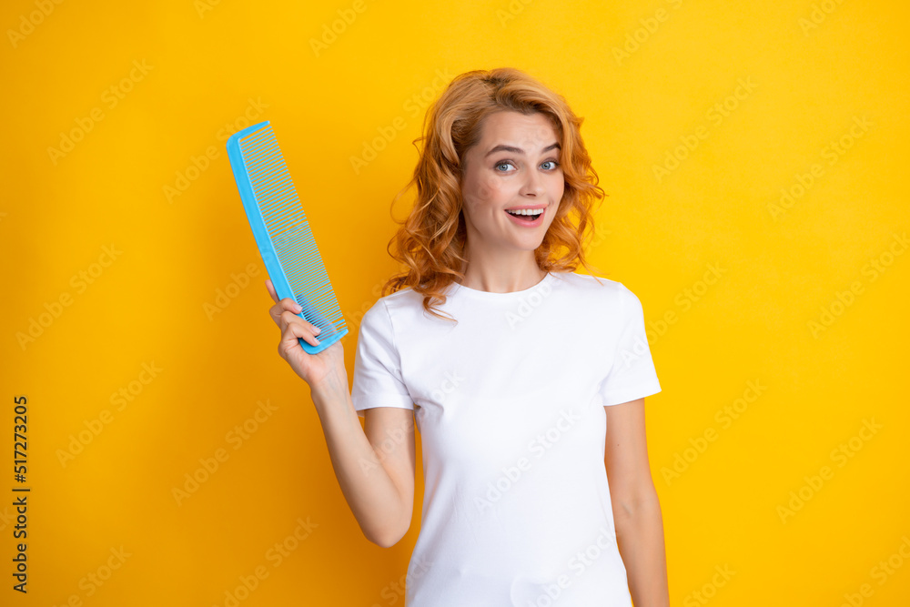 Beauty hair care. Beautiful woman combing hair. Portrait of her she nice-looking attractive lovely well-groomed cheerful holding comb. Hair effect keratin isolated on yellow background. Beauty hair care. Beautiful woman combing hair. Portrait of her she nice-looking attractive lovely well-groomed cheerful holding comb. Hair effect keratin isolated on yellow background.
