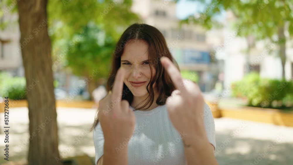 Young woman smiling confident doing bad sign with finger at park Young woman smiling confident doing bad sign with finger at park