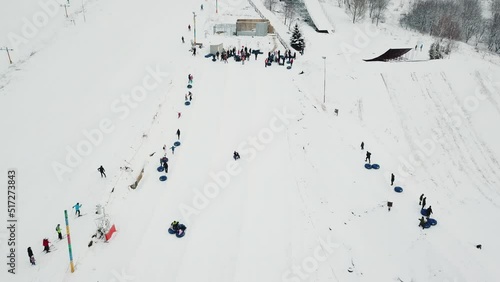 People ride on snow tube. Snow tube resort. Aerial view photo