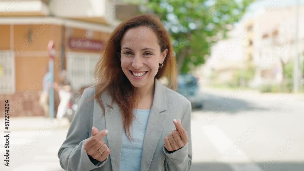 Young woman executive doing spend money gesture at street Young woman executive doing spend money gesture at street