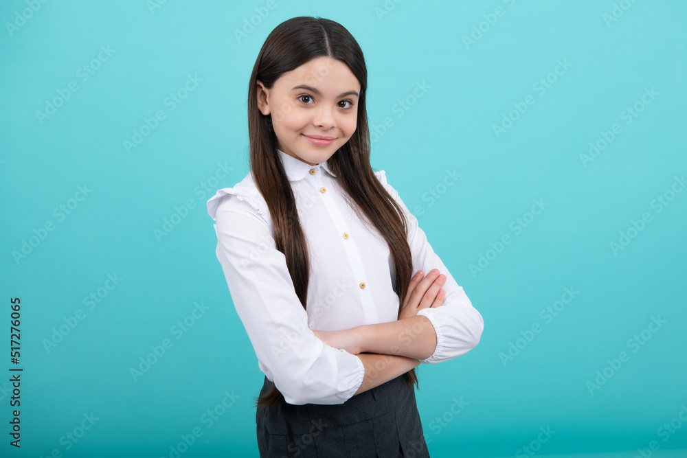 Teenager girl crossed arms isolated on yellow background. Studio portrait of child with mock up copy space. Teenager girl crossed arms isolated on yellow background. Studio portrait of child with mock up copy space.
