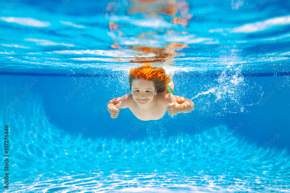 Child swim under water in sea. Kid swimming in pool underwater. Happy boy swims in sea underwater, active kid swimming, playing and diving, children water sport.