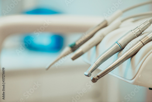 Closeup different dental instruments and tools, blue toning.