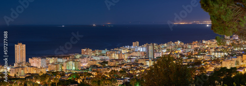 Copy space with dark night sky over the view of a coastal city seen from Signal Hill in Cape Town  South Africa. Calm and scenic panoramic landscape of lights illuminating an urban skyline by the sea