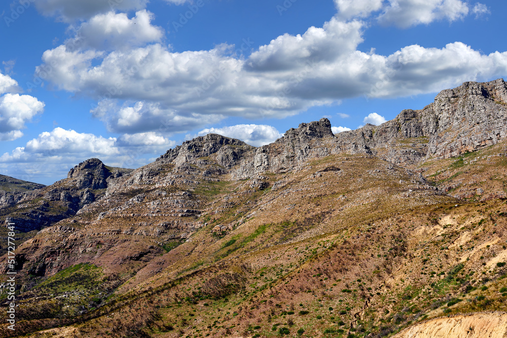 Landscape view of twelve apostles, Cape Town in Western Cape, South Africa. Beautiful scenery of a popular tourist attraction during the day against a cloudy blue sky. Natural landmark for hiking