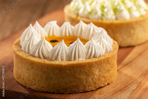 Fotografi Tasty passion fruit tartlet on the table.