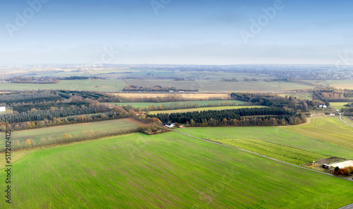 Landscape aerial view of a farm in the countryside in summer. Agricultural field for farming, cultivation, and harvesting from above. An empty piece of land for vineyards, ranching, and growing crop