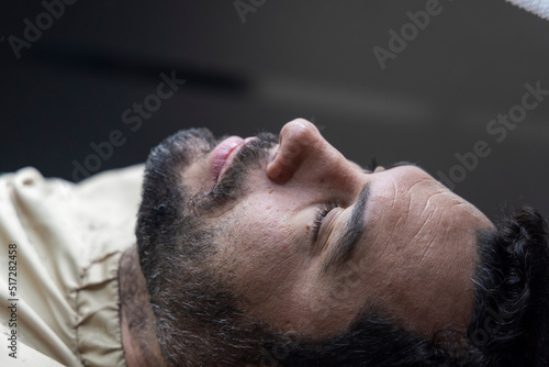 Man lying on barber chair getting ready to shave, Novo Hamburgo barbershop, RS, Brazil