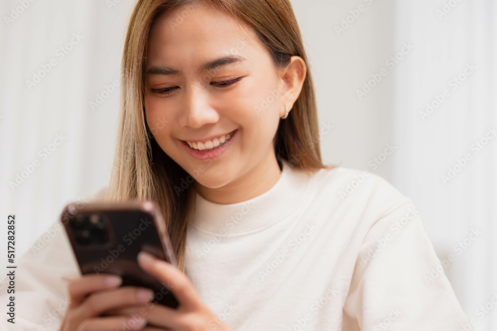 Asian girl using smart phone playing game and social media or chatting with her friends. Asian girl using smart phone playing game and social media or chatting with her friends.