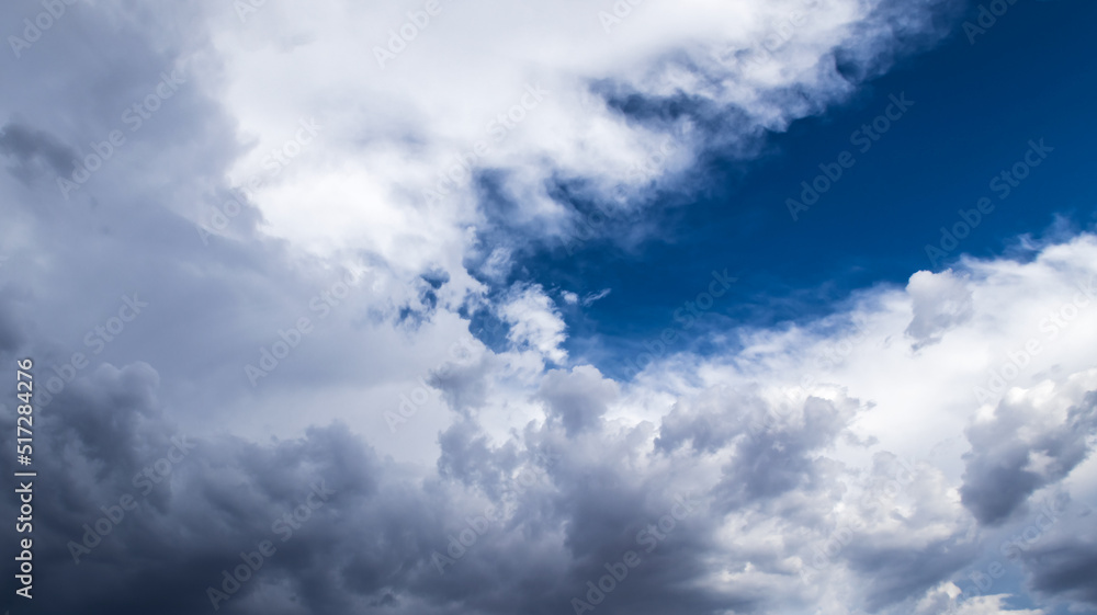 White fluffy cloudscape with blue skies and sun light.