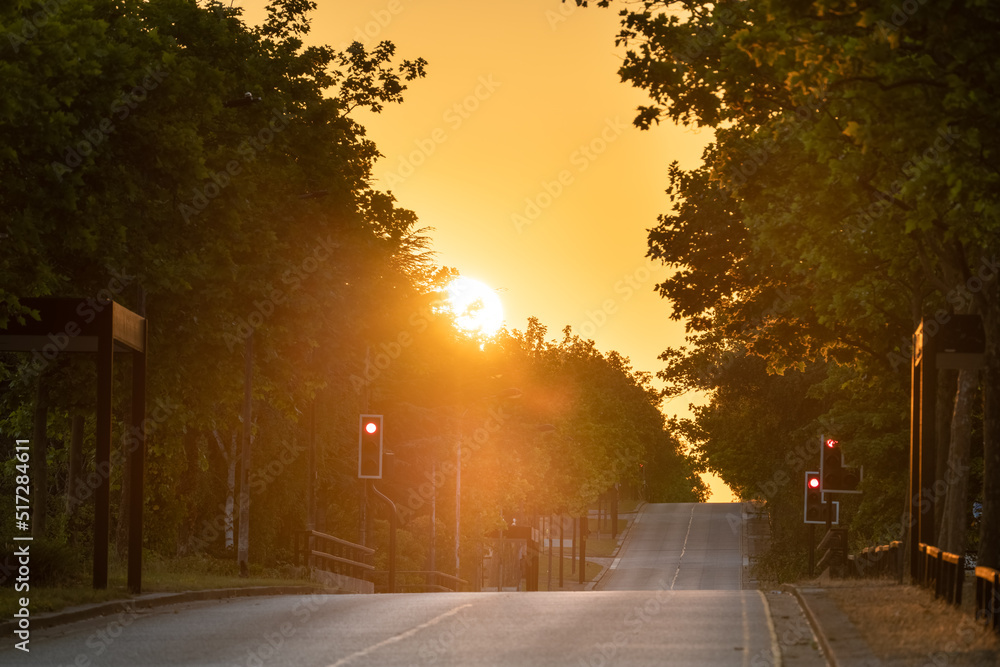Empty road at sunrise. Midsummer boulevard with soft sunrise light in Milton Keynes. England