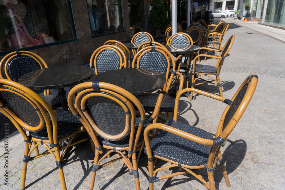 empty tables chairs restaurant street sunny outdoor