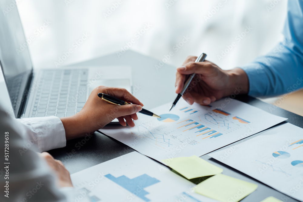 Business People Meeting to discuss and brainstorming the financial report paperwork in home office. Financial advisor teamwork and accounting concept. Business People Meeting to discuss and brainstorming the financial report paperwork in home office. Financial advisor teamwork and accounting concept.