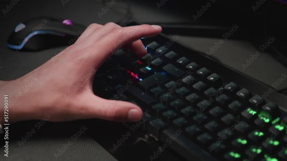 Pressing buttons on a backlit keyboard close-up Pressing buttons on a backlit keyboard close-up