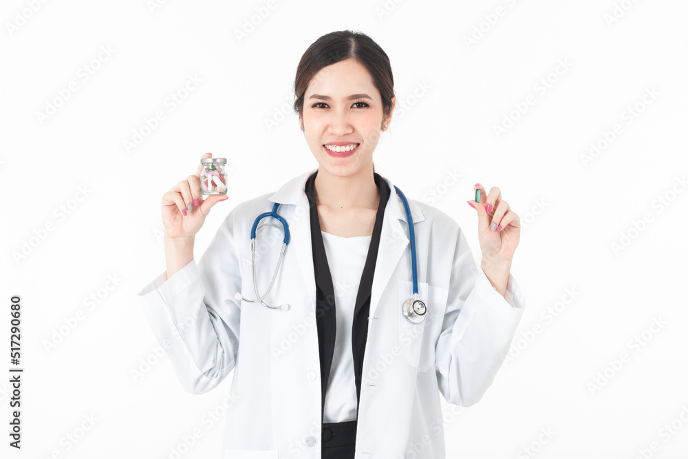 Portrait confident Asian woman doctor and her right hand is showing the Medicine bottle and her left hand showing the pill medium shot isolated on white background. Portrait confident Asian woman doctor and her right hand is showing the Medicine bottle and her left hand showing the pill medium shot isolated on white background.