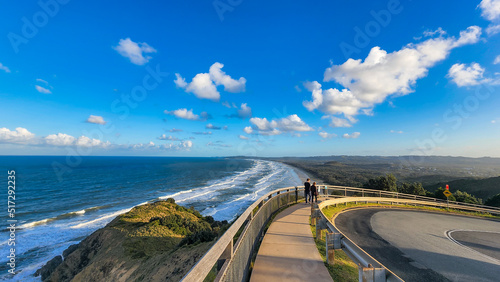 Fotografija People walking along path at Cape Byron with view over Tallow Beach at Byron Bay