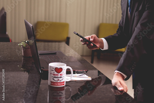 businesmen working on his living room, checking smartphone and laptop, Business concept