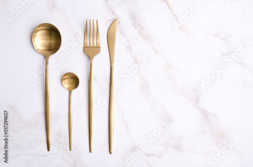 Clean golden metal cutlery