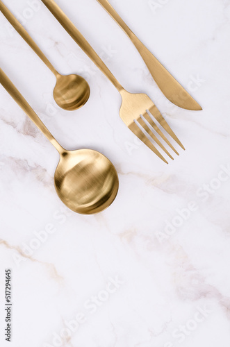 Clean golden metal cutlery