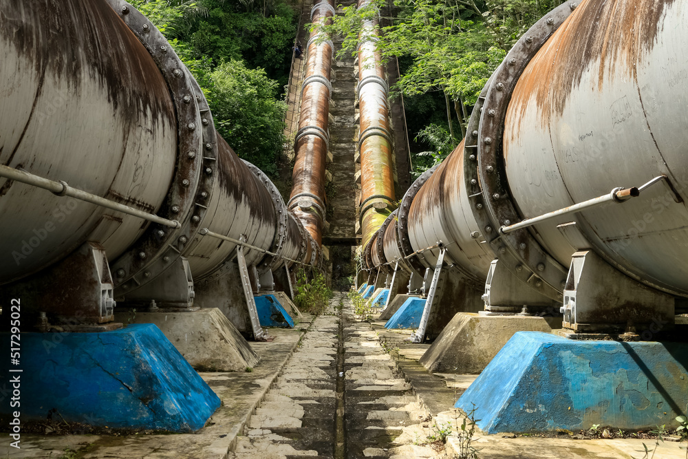 Malang, Indonesia - 07-15-2022 : An amazing view of Syphon Metro, Kepanjen. The giant pipe that connects the flow of two rivers (between metro river and brantas river). Malang, Indonesia - 07-15-2022 : An amazing view of Syphon Metro, Kepanjen. The giant pipe that connects the flow of two rivers (between metro river and brantas river).