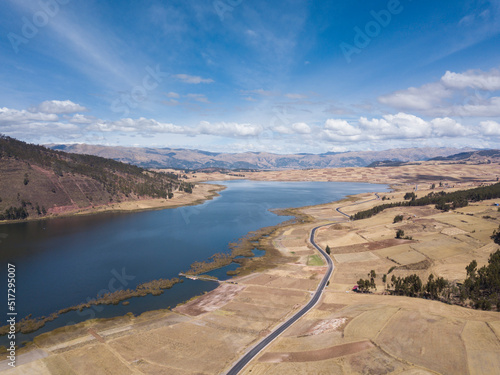 Aerial view of Huaypo Lake. Water source in the high Andes of Cusco Peru. Sunny day in Andean rural landscape.
