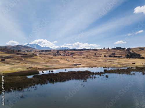 Aerial view of Huaypo Lake. Water source in the high Andes of Cusco Peru. Sunny day in Andean rural landscape.