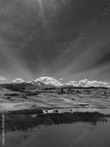 Aerial view of Huaypo Lake. Water source in the high Andes of Cusco Peru. Sunny day in Andean rural landscape.