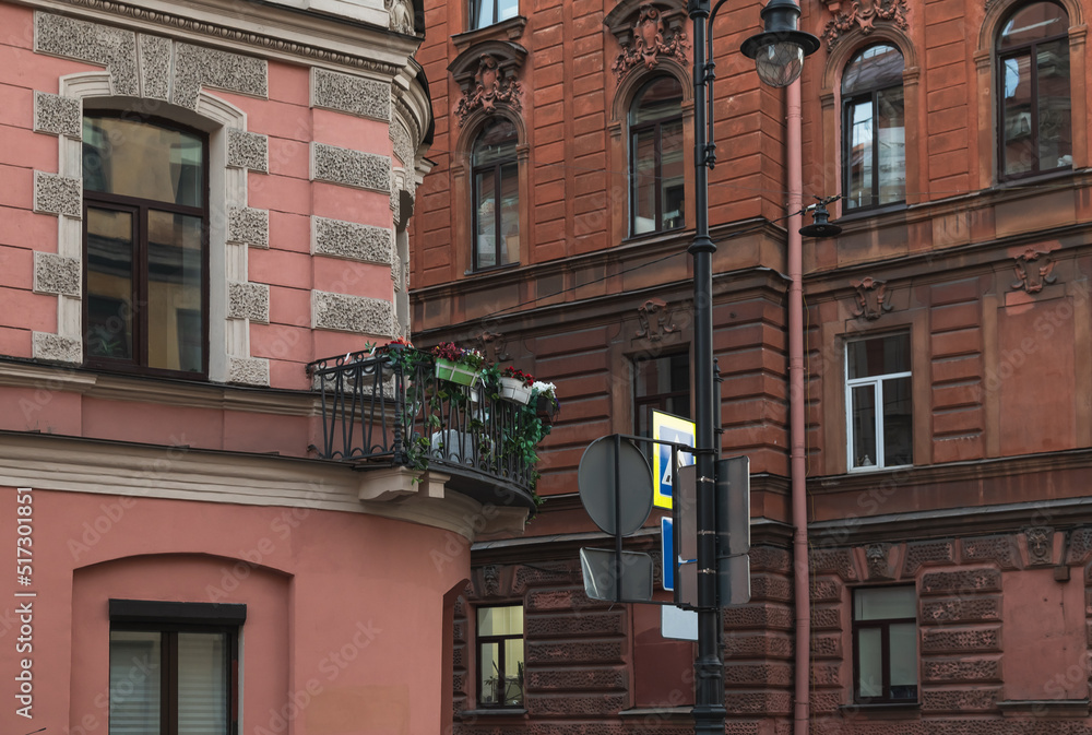 Naklejka premium City street in the evening. Historical facades of houses. Balconies with flowers.