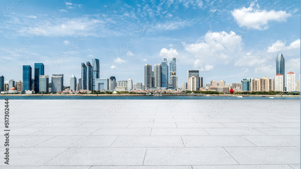 Perspective view of empty concrete tiles floor of rooftop with city skyline