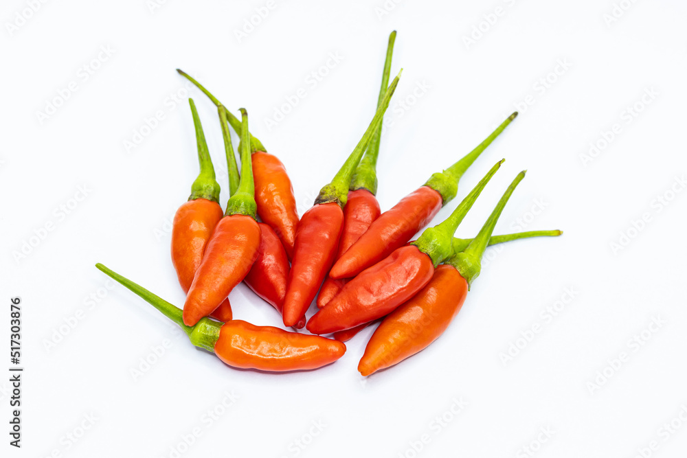 Group of red peppers on a white background separated close-up top view.