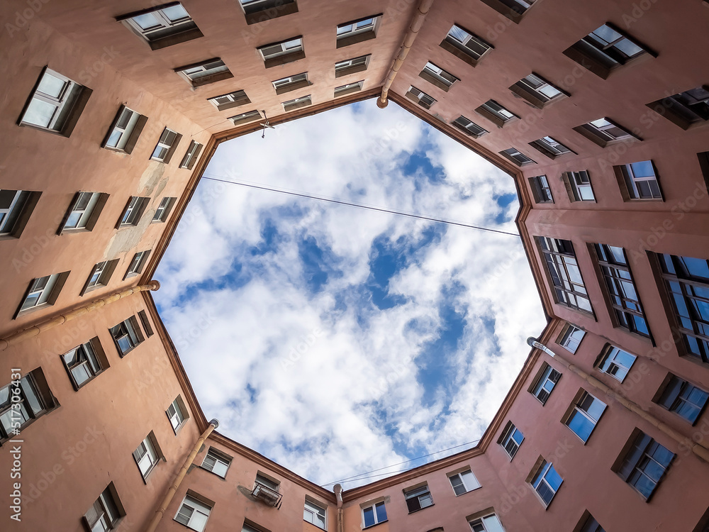 St. Petersburg, Russia, May 10, 2022. Typical for the city courtyard-well on Petrogradskaya side, bottom up view. St. Petersburg, Russia, May 10, 2022. Typical for the city courtyard-well on Petrogradskaya side, bottom up view.