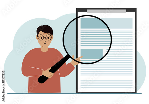 A man holds a magnifying glass and examines a document, contract or agreement. The concept of a lawyer, businessman, or attorney at work.