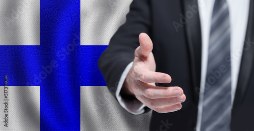 Welcome to the Finland. Hand on Finnish flag background. Business, politics, cooperation and travel concept